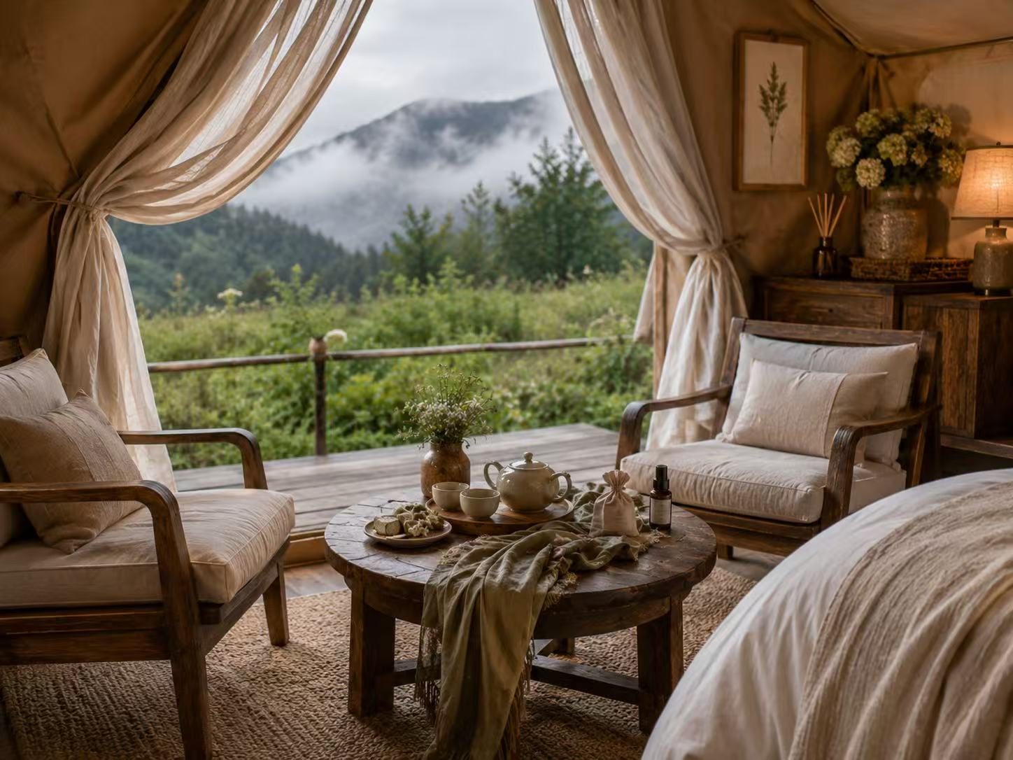 A tea table set for two on a private balcony above the misty valley